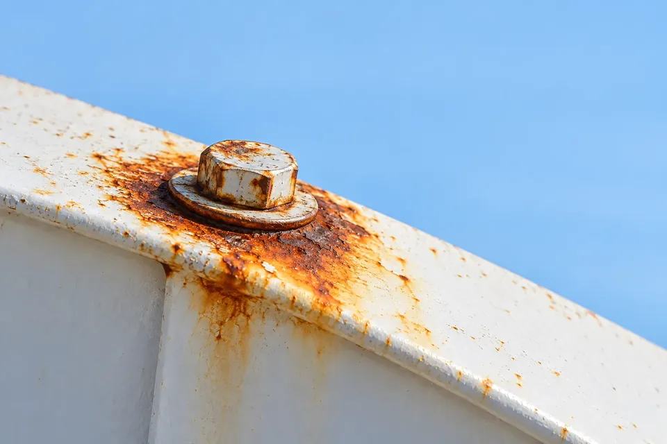 Illustration of corrosion around a fastener on white painted roof-edge trim