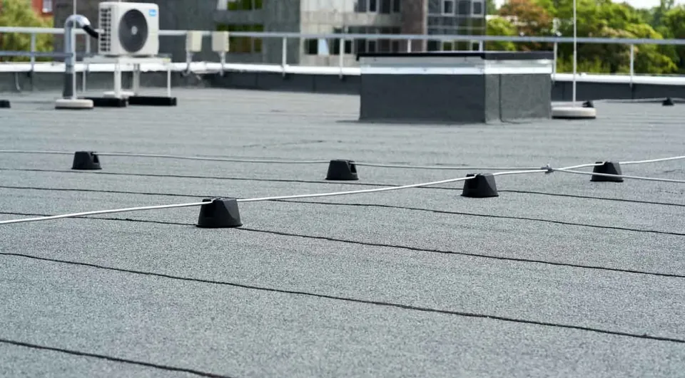 Low-slope roof with membrane seams, rooftop equipment and supported lines